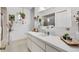 Bright bathroom featuring a white vanity, large mirror, and decorative butterfly accents at 10385 Se 178Th St, Summerfield, FL 34491