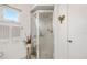 Bathroom featuring a glass-enclosed shower and a floral display at 10385 Se 178Th St, Summerfield, FL 34491