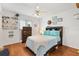 Relaxing bedroom featuring wood laminate flooring and cheerful decorations at 10385 Se 178Th St, Summerfield, FL 34491