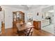 Traditional dining area featuring hardwood floors, a classic china cabinet, and views into the kitchen and living spaces at 10385 Se 178Th St, Summerfield, FL 34491