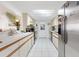 Bright kitchen features white cabinetry, stainless steel refrigerator, and a skylight for natural light at 10385 Se 178Th St, Summerfield, FL 34491
