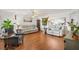 Bright living room with wood floors, modern furniture, and ample space, perfect for relaxation and entertaining at 10385 Se 178Th St, Summerfield, FL 34491
