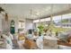 Cozy sunroom with ample seating, ceiling fan, and natural light streaming through the large windows at 10385 Se 178Th St, Summerfield, FL 34491