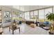 Relaxing sunroom featuring multiple windows, comfortable seating, and serene backyard views at 10385 Se 178Th St, Summerfield, FL 34491