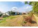 Large backyard with lush landscaping, a well-maintained lawn, and a view of neighboring properties at 10445 Sw 90Th Street Rd, Ocala, FL 34481