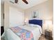 Cozy bedroom with bright blue accents, a ceiling fan, and a well-lit lamp at 10445 Sw 90Th Street Rd, Ocala, FL 34481