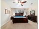 Spacious bedroom boasting a large window, neutral walls, and dark wood furniture at 10445 Sw 90Th Street Rd, Ocala, FL 34481