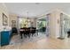 Charming dining room with natural light, chandelier, and sliding doors to the outdoor living space at 10445 Sw 90Th Street Rd, Ocala, FL 34481