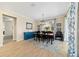 Bright dining room with wood floors, stylish curtains, and natural light at 10445 Sw 90Th Street Rd, Ocala, FL 34481
