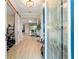 Inviting foyer with decorative glass front door, wood-look tile flooring, and open floor plan at 10445 Sw 90Th Street Rd, Ocala, FL 34481