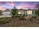 Charming single-story home featuring a three-car garage, covered porch, and landscaped front yard at 10445 Sw 90Th Street Rd, Ocala, FL 34481