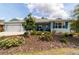 Charming single-story home featuring a three-car garage, covered porch, and landscaped front yard at 10445 Sw 90Th Street Rd, Ocala, FL 34481