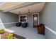 Inviting front porch with seating, pendant lighting, and stylish front door with glass detailing at 10445 Sw 90Th Street Rd, Ocala, FL 34481