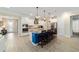 Stylish kitchen featuring white cabinets, modern appliances, granite countertops, and an island with barstool seating at 10445 Sw 90Th Street Rd, Ocala, FL 34481