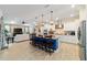 Open kitchen with island seating, stainless steel appliances, and a view of the living area at 10445 Sw 90Th Street Rd, Ocala, FL 34481