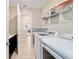 Well-equipped laundry room with modern washer and dryer, shelving, and convenient counter space at 10445 Sw 90Th Street Rd, Ocala, FL 34481