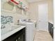 Modern laundry room with front load washer and dryer, with shelving and sink at 10445 Sw 90Th Street Rd, Ocala, FL 34481
