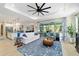 Open-concept living room with a large rug, adjacent to the kitchen, offering comfortable seating and style at 10445 Sw 90Th Street Rd, Ocala, FL 34481