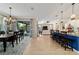 Open-concept living room features a breakfast bar, dining area, and sliding glass doors to a screened-in patio at 10445 Sw 90Th Street Rd, Ocala, FL 34481