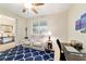Comfortable living room featuring a blue pattern rug, ceiling fan, and a recliner sofa at 10445 Sw 90Th Street Rd, Ocala, FL 34481