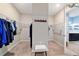 Organized walk-in closet with ample storage space, featuring built-in shelving and a central bench at 10445 Sw 90Th Street Rd, Ocala, FL 34481