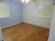 The bedroom features two windows for natural light, light blue and white paint and wood floors at 10955 Sw 89Th Ave, Ocala, FL 34481