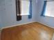 Bedroom featuring light blue walls, wood flooring and natural light at 10955 Sw 89Th Ave, Ocala, FL 34481