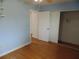 This cozy bedroom features light blue walls, wood flooring, and a spacious closet at 10955 Sw 89Th Ave, Ocala, FL 34481