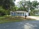 Charming single-story home with blue siding, attached garage and well-manicured lawn at 10955 Sw 89Th Ave, Ocala, FL 34481