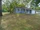 Single-story home with blue siding, a one-car garage, and a well-maintained front lawn at 10955 Sw 89Th Ave, Ocala, FL 34481
