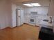An eat-in kitchen features white cabinets, appliances, and hardwood floors at 10955 Sw 89Th Ave, Ocala, FL 34481