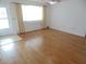 Spacious living room with wood floors and natural light from large window at 10955 Sw 89Th Ave, Ocala, FL 34481
