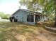 Rear view of home with blue siding, highlighting the enclosed porch and backyard at 10955 Sw 89Th Ave, Ocala, FL 34481