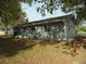Home with blue siding, featuring a screened-in porch and a spacious backyard at 10955 Sw 89Th Ave, Ocala, FL 34481