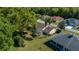 An aerial view of the property featuring a screened lanai, mature trees, and well-maintained landscaping at 11645 Sw 75Th Cir, Ocala, FL 34476