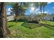 Lush green backyard with mature trees and screened-in patio providing ample shade at 11645 Sw 75Th Cir, Ocala, FL 34476