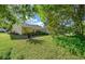 Expansive backyard with lush greenery and a partially obscured view of the house at 11645 Sw 75Th Cir, Ocala, FL 34476
