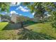 Lush backyard with a screened lanai and mature palm trees, providing a private outdoor oasis at 11645 Sw 75Th Cir, Ocala, FL 34476