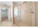Bright bathroom showcasing a glass-enclosed shower with hand-held sprayer and a tile floor at 11645 Sw 75Th Cir, Ocala, FL 34476