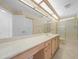 Bathroom featuring a long vanity with double sinks and a glass-enclosed shower at 11645 Sw 75Th Cir, Ocala, FL 34476