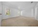 Spacious carpeted bedroom with a pair of windows allowing plenty of natural light to enter the room at 11645 Sw 75Th Cir, Ocala, FL 34476