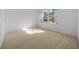 Bright bedroom with white walls, a carpeted floor, and a window at 11645 Sw 75Th Cir, Ocala, FL 34476