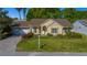 Inviting single-story home featuring an attached garage, manicured lawn, and mature trees at 11645 Sw 75Th Cir, Ocala, FL 34476