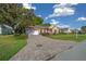 Exterior of home featuring a paver driveway, well-maintained lawn, and attached garage at 11645 Sw 75Th Cir, Ocala, FL 34476