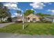 Charming front exterior view of home featuring a manicured lawn, mailbox, and attached garage at 11645 Sw 75Th Cir, Ocala, FL 34476