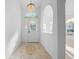 Elegant entryway with decorative tile flooring, chandelier, and arched doorway at 11645 Sw 75Th Cir, Ocala, FL 34476