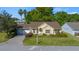 Charming home featuring lush landscaping, a brick driveway, and an attached garage at 11645 Sw 75Th Cir, Ocala, FL 34476