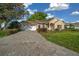 Lovely home showcasing a brick driveway, attached garage, and well-maintained lawn at 11645 Sw 75Th Cir, Ocala, FL 34476