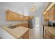 Well-lit kitchen with stainless steel appliances, wood cabinets, and tiled flooring at 11645 Sw 75Th Cir, Ocala, FL 34476