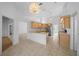 Spacious kitchen featuring wood cabinets, tiled floor, and breakfast bar area at 11645 Sw 75Th Cir, Ocala, FL 34476